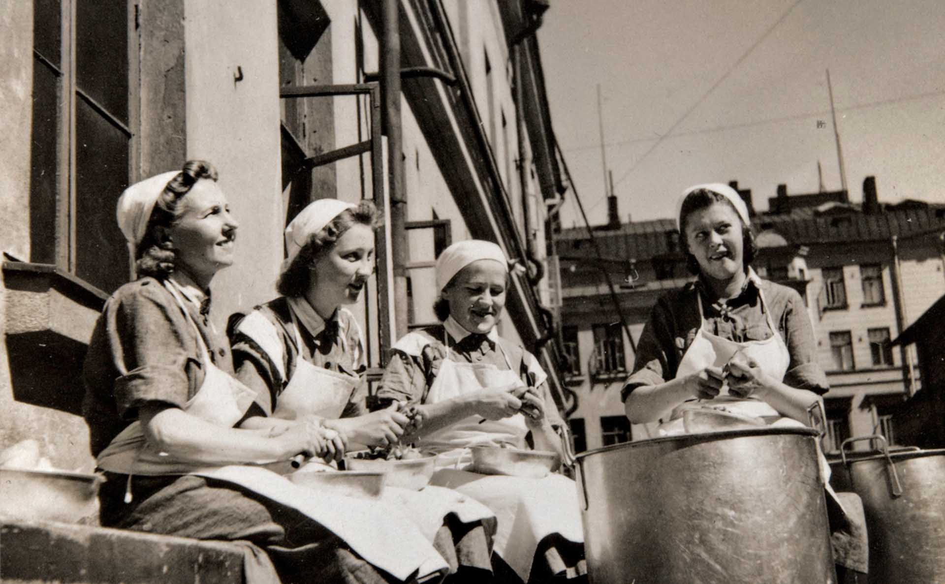 Lotta Svärd-järjestön muonitusjaostoon kuuluvia naisia kuorimassa perunoita vuonna 1941. Kuva: Helsingin kaupunginmuseo